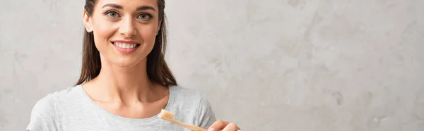 Young woman with toothbrush looking at camera, banner — Stock Photo
