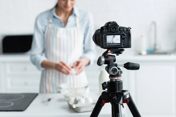 Selective focus of digital camera near cropped culinary blogger during online cooking — Stock Photo