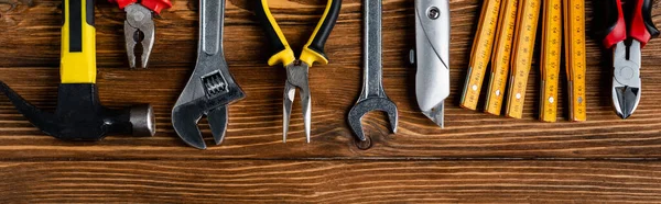 Top view of various tools on wooden surface, labor day concept, banner — Stock Photo