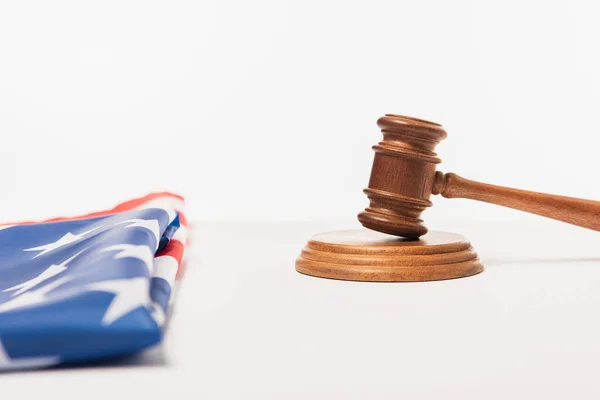 Wooden gavel near american flag on white — Stock Photo