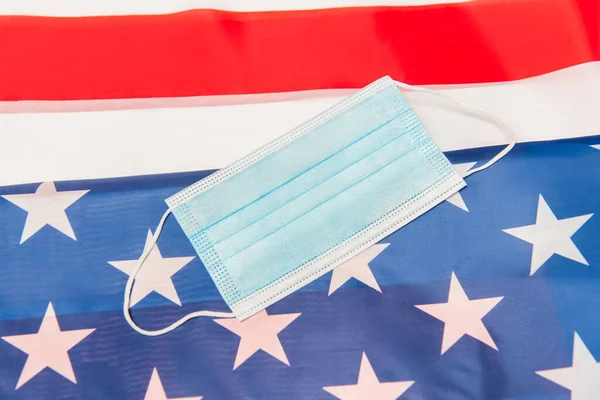 Top view of blue medical mask on american flag — Stock Photo