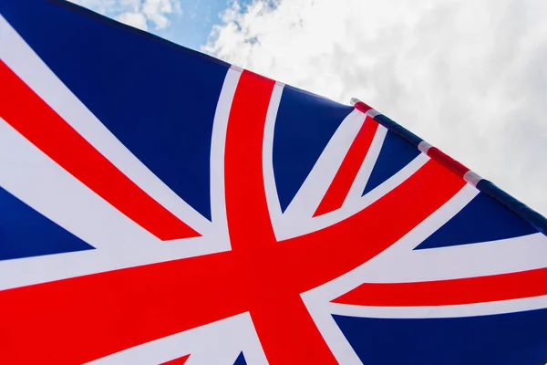 Close up view of national flag of united kingdom with red cross against sky — Stock Photo