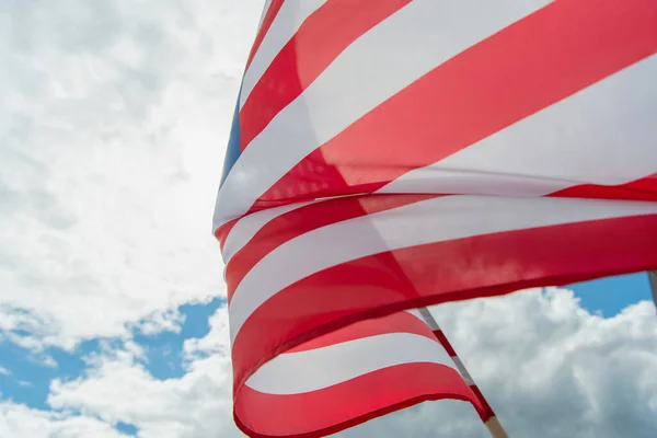 Close up view of american flag with stars and stripes against cloudy sky — Stock Photo