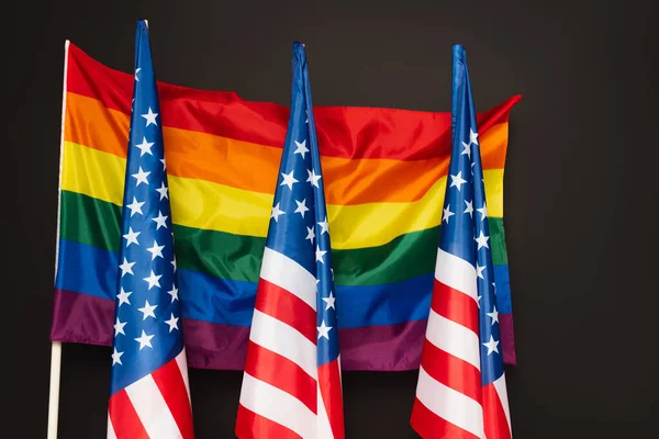 American and colorful lgbt flags isolated on black — Stock Photo