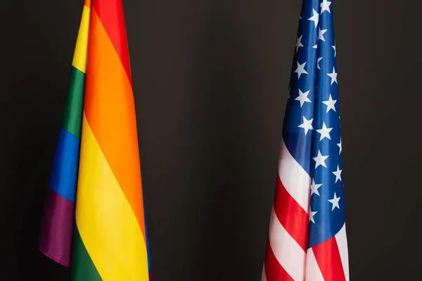 American and colorful lgbt flags isolated on black — Stock Photo