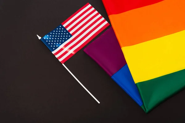 High angle view of american and lgbt flags isolated on black, equality rights concept — Stock Photo