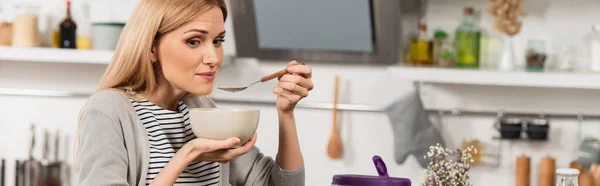 Blonde woman having breakfast in kitchen, banner — Stock Photo