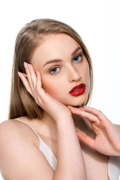 Bonita mujer joven con ojos azules y labios rojos mirando a la cámara aislada en blanco - foto de stock