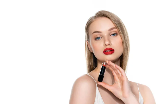 Pretty young woman with blue eyes and red lips holding lipstick isolated on white — Stock Photo