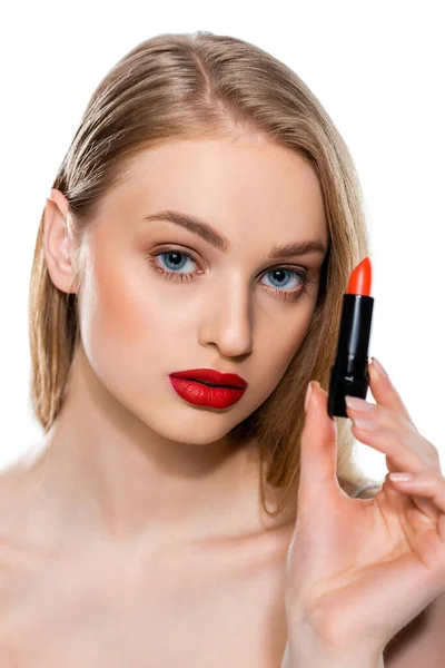 Pretty woman with blue eyes and red lips holding lipstick tube isolated on white — Stock Photo