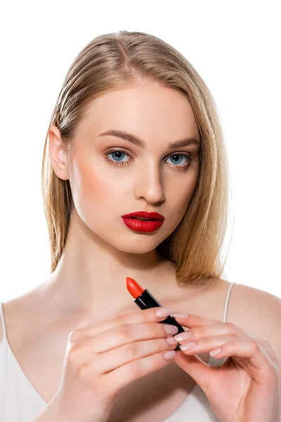 Young woman with red lips holding lipstick tube isolated on white — Stock Photo