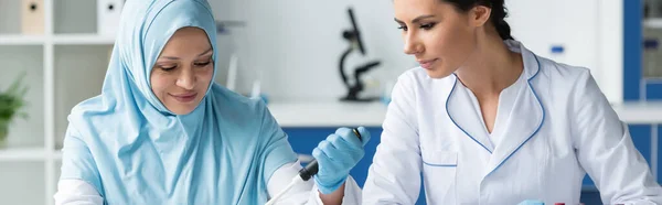 Interracial scientists working with electronic pipette in lab, banner — Stock Photo