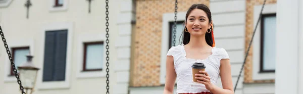 Happy asian woman with takeaway drink smiling outdoors, banner — Stock Photo
