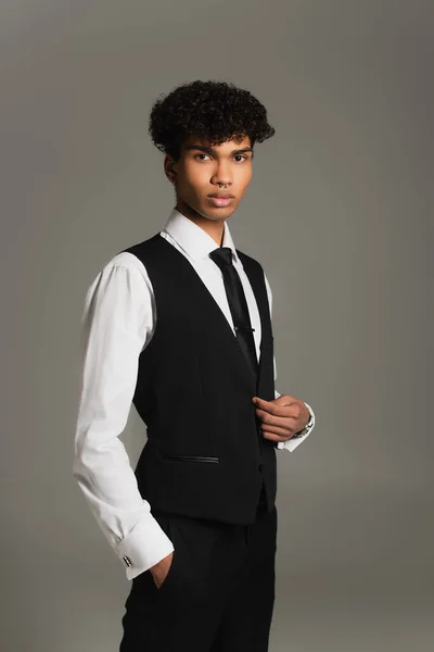Елегантний афроамериканський чоловік стоїть з рукою в кишені ізольовано на сірому — стокове фото