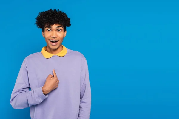 Surprised african american man pointing with finger at himself isolated on blue — Stock Photo