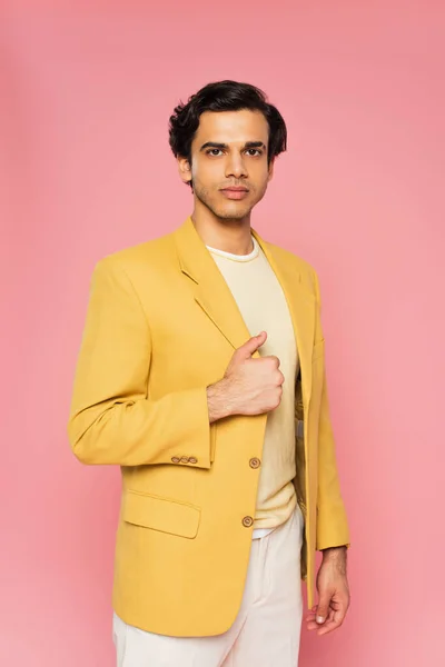 Young man in trendy yellow blazer posing isolated on pink — Stock Photo