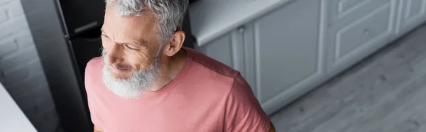 High angle view of mature man standing in kitchen, banner — Stock Photo