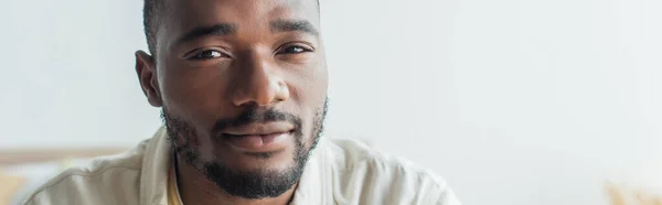 Junger afrikanisch-amerikanischer Mann blickt in die Kamera, Banner — Stockfoto