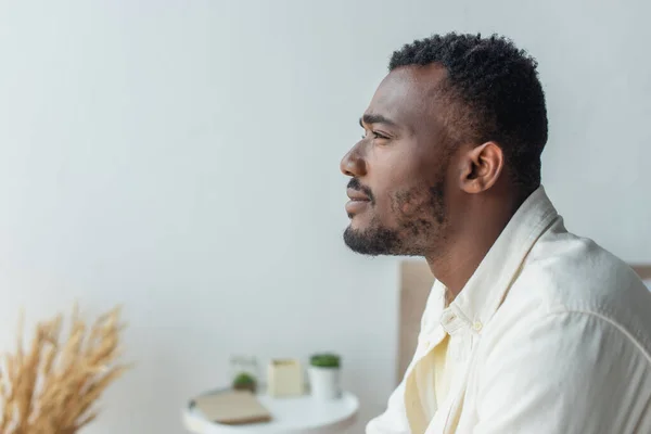Side view of pensive young african american man looking away — Stock Photo