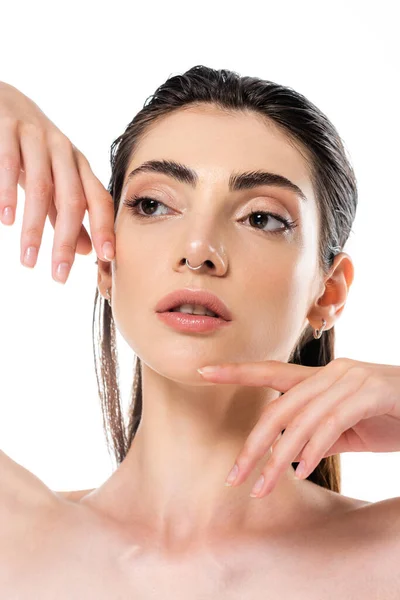 Young and pierced woman with bare shoulders looking away isolated on white — Stock Photo