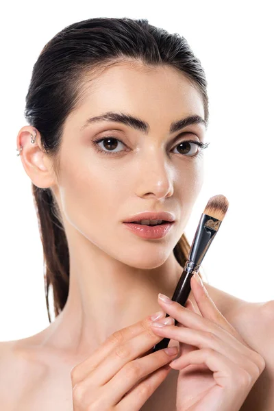 Young woman holding cosmetic brush isolated on white — Stock Photo