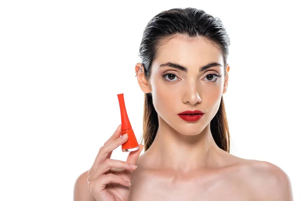 Young woman holding bottle with orange nail polish isolated on white — Stock Photo