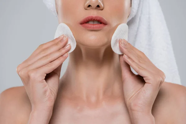 Cropped view of young woman removing makeup with cotton pads isolated on grey — Stock Photo