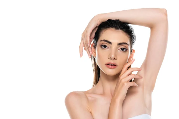 Brunette young woman with bare shoulders posing and looking at camera isolated on white — Stock Photo