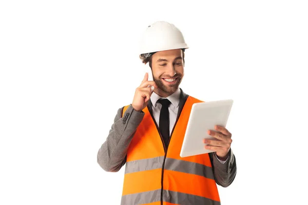 Engineer talking on cellphone and holding digital tablet isolated on white — Stock Photo