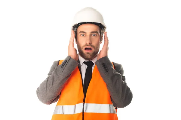 Astonished architect in hard hat looking at camera isolated on white — Stock Photo