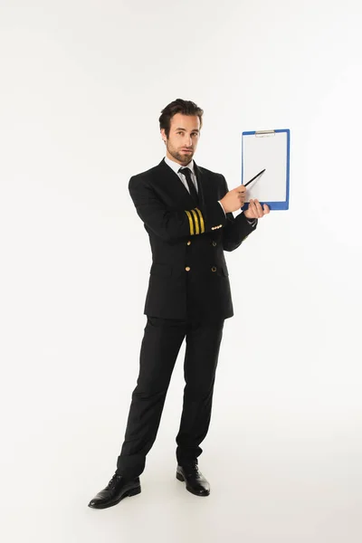 Aviator pointing at clipboard on white background — Stock Photo