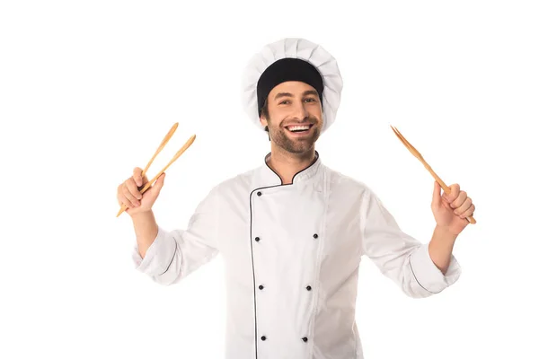 Smiling chef holding wooden tweezers isolated on white — Stock Photo