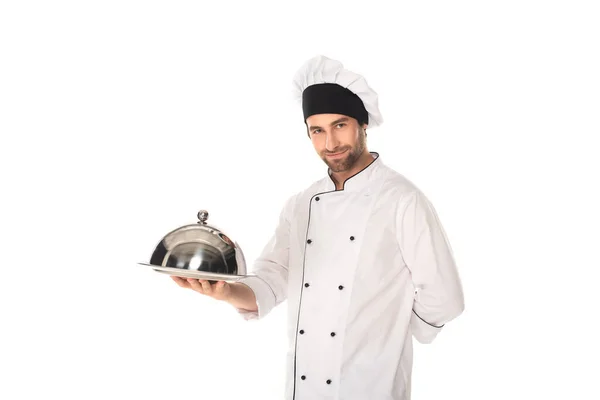 Chef in uniform holding cloche and tray isolated on white — Stock Photo