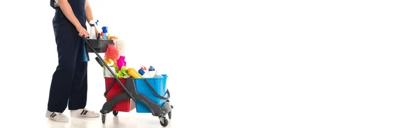 Cropped view of cleaner holding cart with detergents on white background, banner — Stock Photo