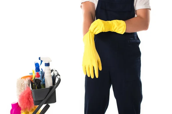 Cropped view of cleaner wearing rubber gloves near detergents isolated on white — Stock Photo