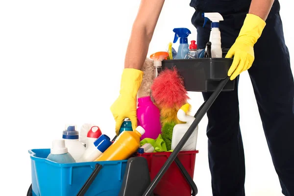 Cropped view of cleaner taking detergent from cart isolated on white — Stock Photo