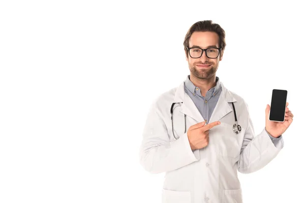 Médico sonriente apuntando a teléfono inteligente aislado en blanco - foto de stock