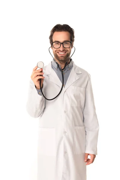 Positive doctor holding stethoscope and looking at camera isolated on white — Stock Photo