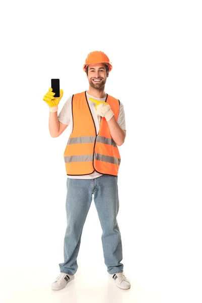 Constructeur souriant pointant vers le smartphone avec écran blanc sur fond blanc — Photo de stock