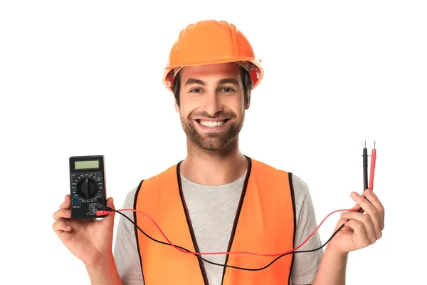 Construtor sorridente segurando testador elétrico isolado em branco — Fotografia de Stock