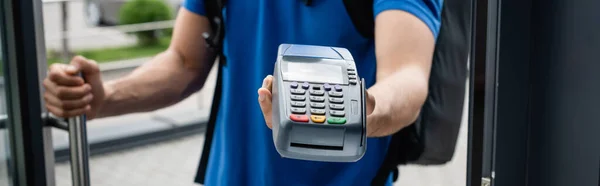 Cropped view of courier holding payment terminal, banner — Stock Photo