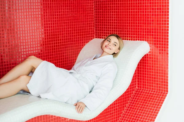 Young woman lying on lounge chair in spa center — Stock Photo