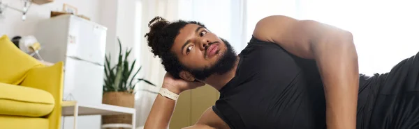 Athletic man exercising at home, focusing on fitness while showcasing diversity and strength, banner — Stock Photo