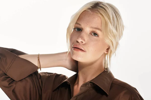 Mujer rubia posa con elegancia en traje de invierno, abrazando estilos de moda en un estudio blanco. - foto de stock