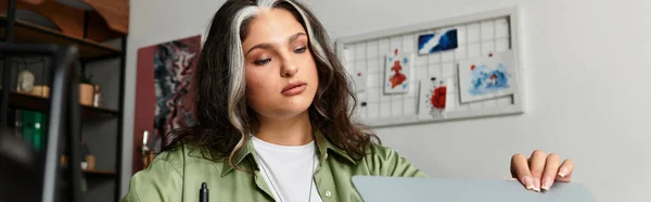 A woman with a white forelock focuses on her work in a stylish home space, banner — Stock Photo