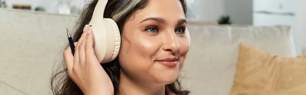A woman with a white forelock relaxes at home, listening to music with joy, banner — Stock Photo