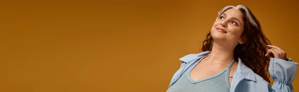 Una giovane donna posa con grazia in uno studio, mettendo in evidenza il suo aspetto distinto e il suo senso della moda, banner — Foto stock