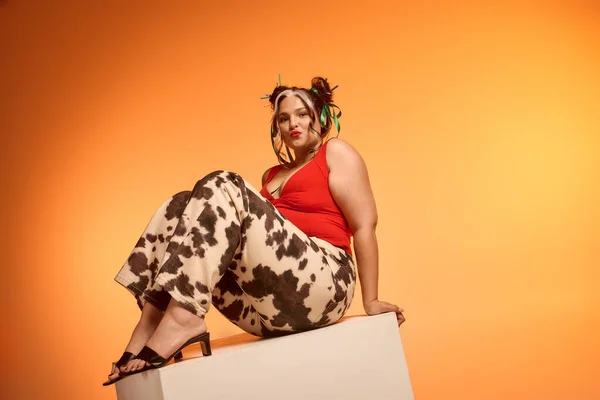 Young woman with Waardenburg syndrome showcases her style against a bright orange backdrop. — Stock Photo