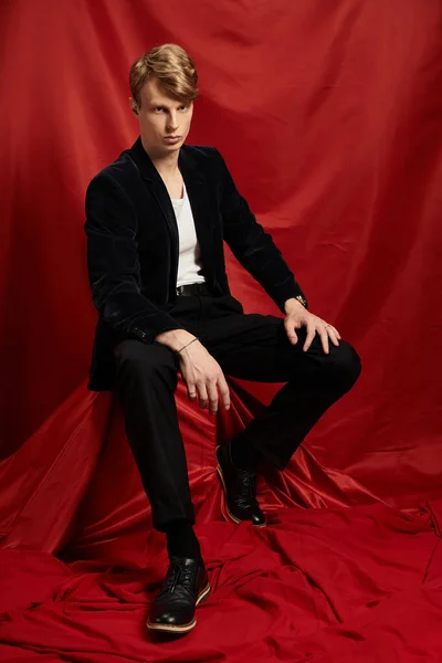 Un joven posa con confianza en un atuendo elegante, encarnando la masculinidad moderna. - foto de stock