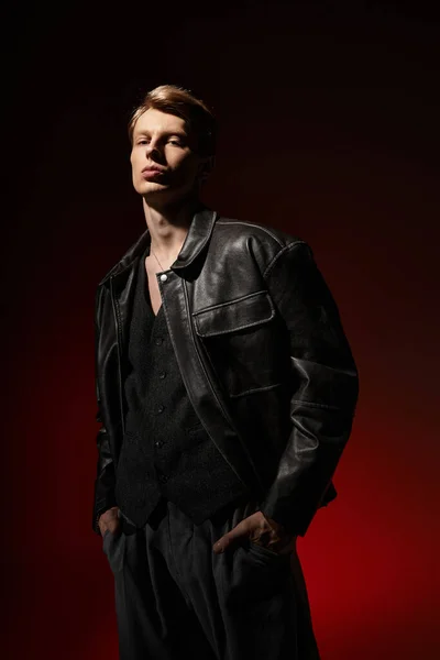 Красивий молодий чоловік впевнено позує в шкіряній куртці з сучасним, привабливим шармом. — стокове фото